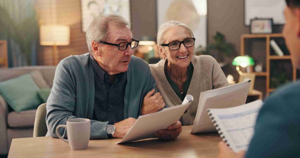 Older business owner in glasses discussing retirement plans with a financial advisor