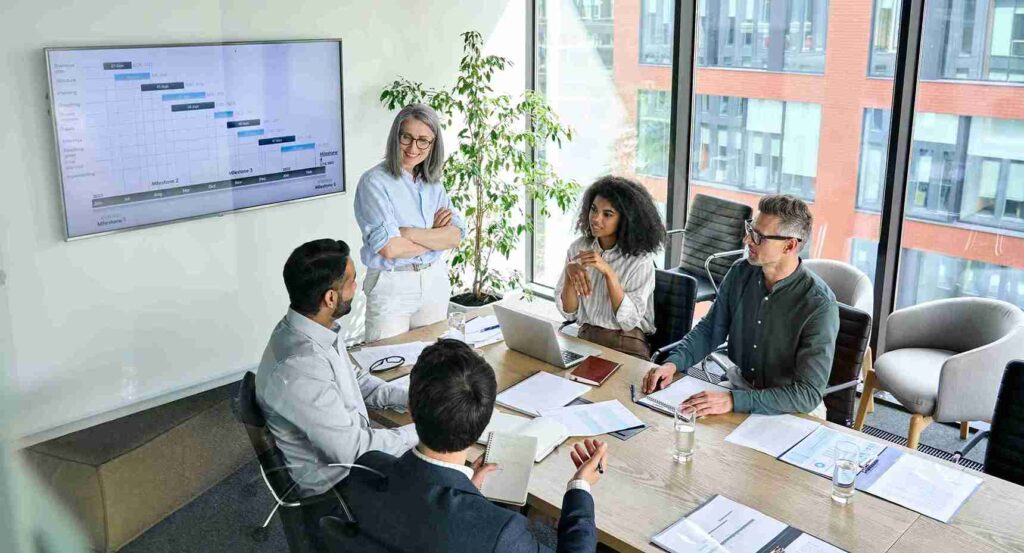 Professional female financial advisor with glasses leading an employee retirement planning meeting