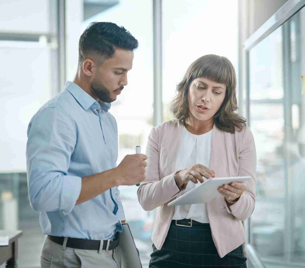 Financial advisor reviewing portfolio details on a tablet with a client