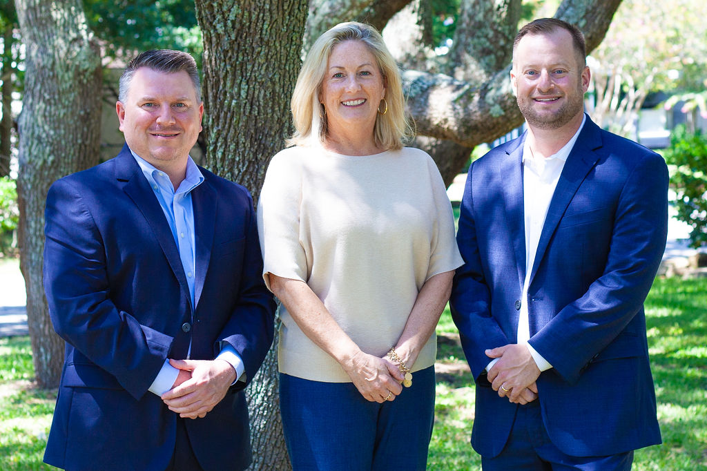 The Oak Street Advisors team standing together under an oak tree